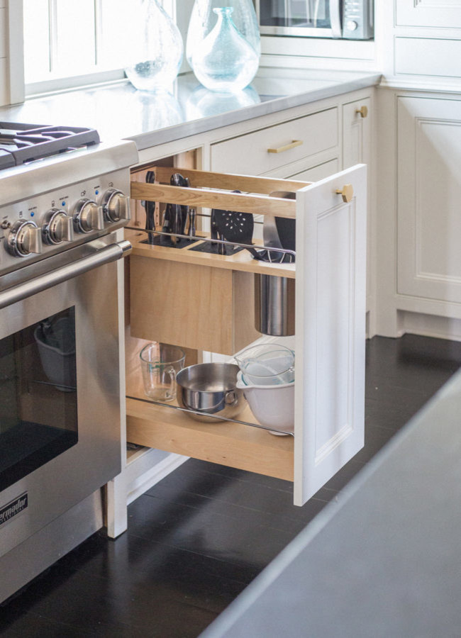 Large transitional u-shaped dark wood floor enclosed kitchen photo with an undermount sink, recessed-panel cabinets, white cabinets, granite countertops, white backsplash, stainless steel appliances and an island
