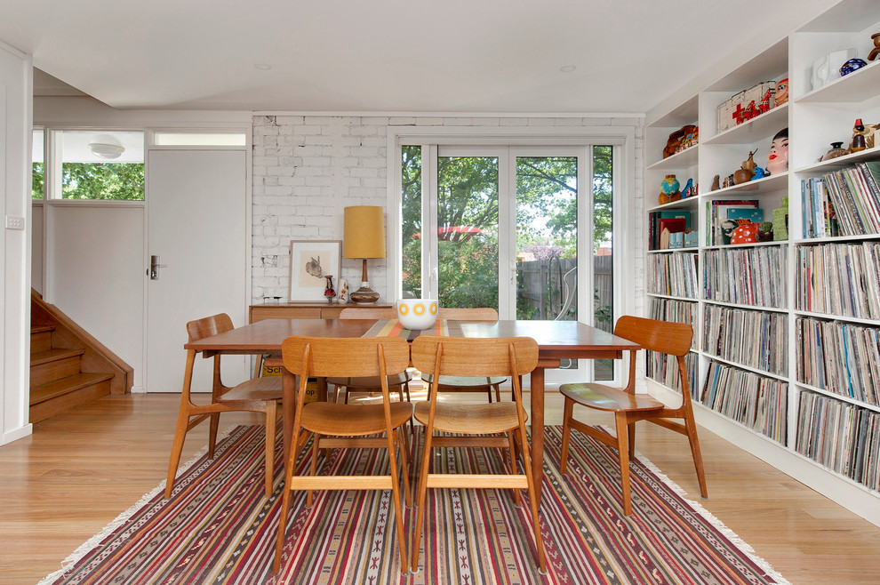 This is an example of a scandinavian dining room in Canberra - Queanbeyan with white walls and light hardwood floors.