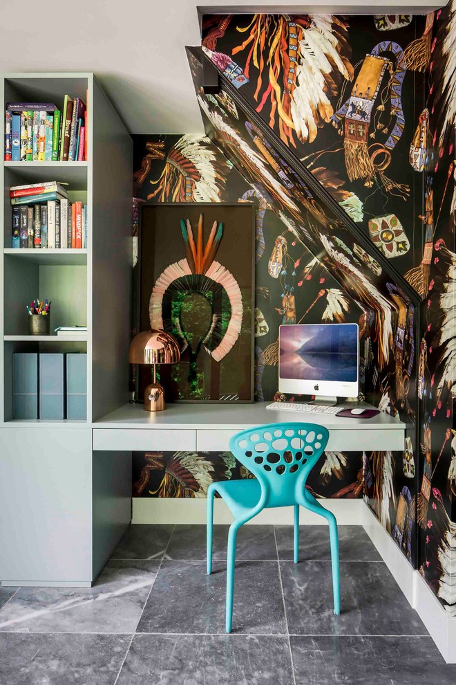 Photo of an eclectic home office in Amsterdam with multi-coloured walls, a built-in desk and grey floor.