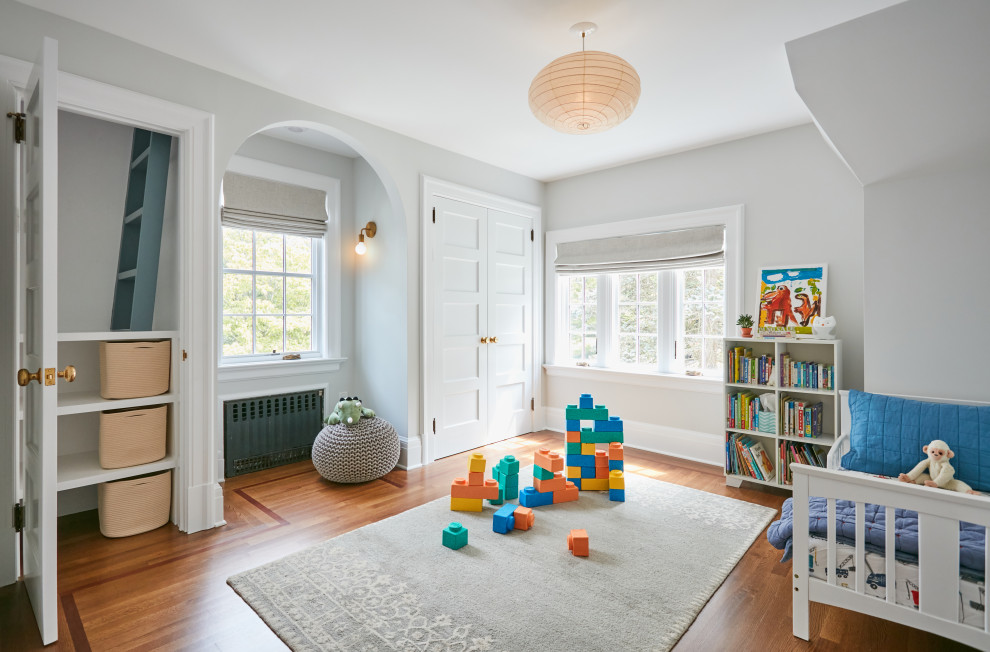 Inspiration for a large traditional nursery in New York with grey walls, medium hardwood flooring and brown floors.
