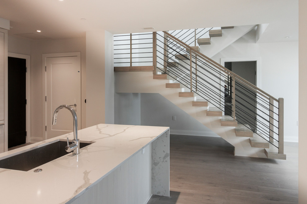 Inspiration for a large contemporary wood u-shaped staircase in DC Metro with cable railing.