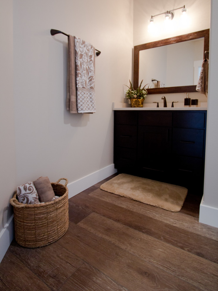 This is an example of a traditional bathroom in Other with vinyl floors and brown floor.