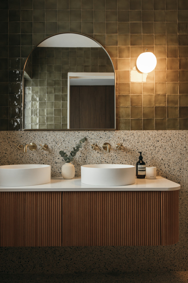 This is an example of a midcentury bathroom in Central Coast with flat-panel cabinets, medium wood cabinets, multi-coloured tile, terrazzo floors, a vessel sink, multi-coloured floor, white benchtops, a single vanity and a floating vanity.