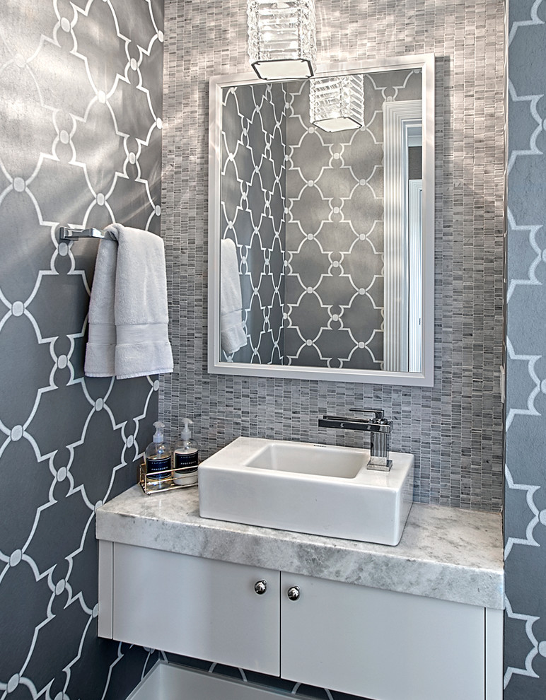 Small transitional powder room in Chicago with flat-panel cabinets, white cabinets, grey walls, a vessel sink, marble benchtops, gray tile, mosaic tile, grey benchtops, a floating vanity and wallpaper.