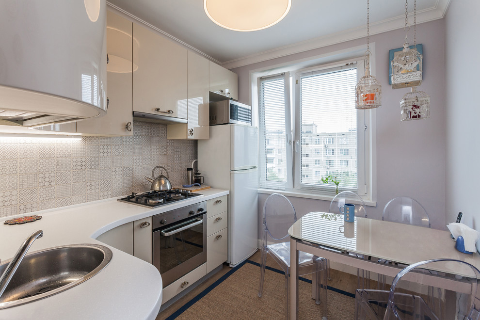 Small transitional l-shaped separate kitchen in Moscow with a drop-in sink, flat-panel cabinets, beige cabinets, solid surface benchtops, beige splashback, ceramic splashback, laminate floors and beige floor.