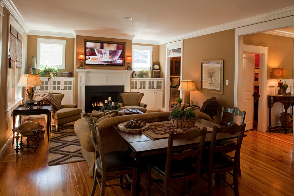 This is an example of a mid-sized arts and crafts enclosed family room in Richmond with beige walls, medium hardwood floors, a standard fireplace, a metal fireplace surround and a wall-mounted tv.