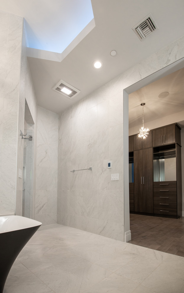 Design ideas for a large modern master bathroom in Phoenix with flat-panel cabinets, black cabinets, a freestanding tub, an open shower, a one-piece toilet, white tile, slate, white walls, slate floors, a drop-in sink, granite benchtops, white floor, an open shower, multi-coloured benchtops, an enclosed toilet, a double vanity, a floating vanity and recessed.