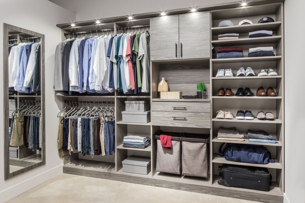 Photo of a large contemporary men's walk-in wardrobe in Seattle with open cabinets, grey cabinets, light hardwood floors and beige floor.
