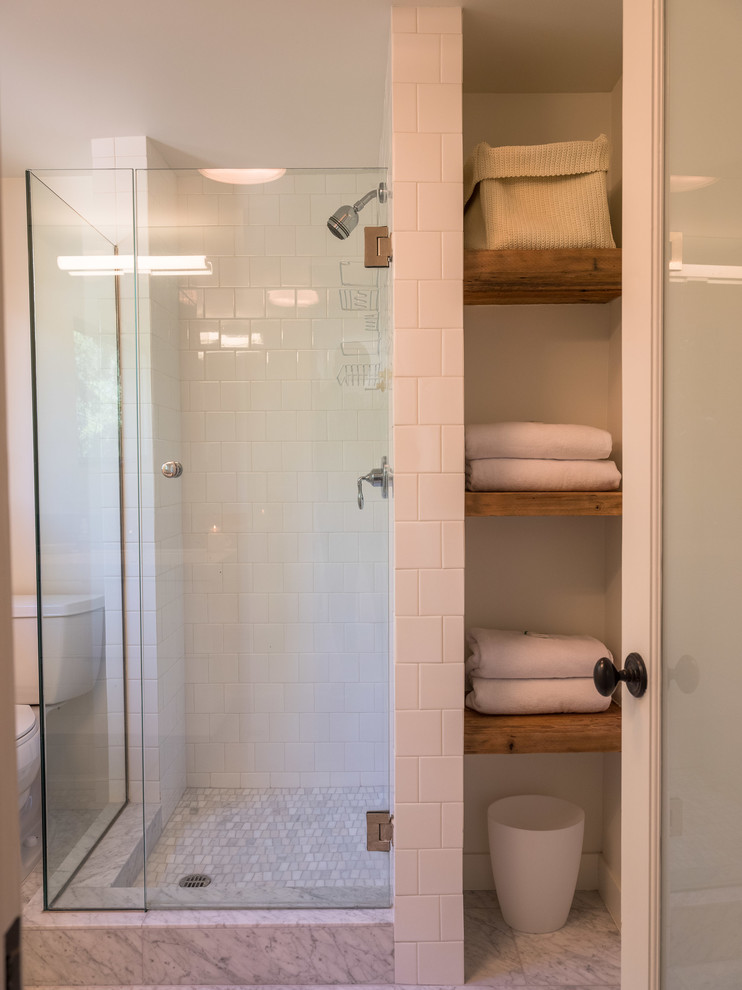 Mid-sized contemporary kids bathroom in Los Angeles with open cabinets, dark wood cabinets, a corner shower, a two-piece toilet, white tile, mosaic tile, white walls, marble floors, wood benchtops, white floor and a hinged shower door.