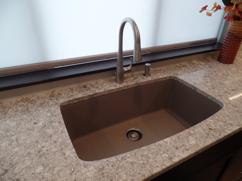 Large transitional l-shaped medium tone wood floor and beige floor eat-in kitchen photo in Cedar Rapids with an undermount sink, shaker cabinets, dark wood cabinets, granite countertops, white backsplash, subway tile backsplash, stainless steel appliances and an island