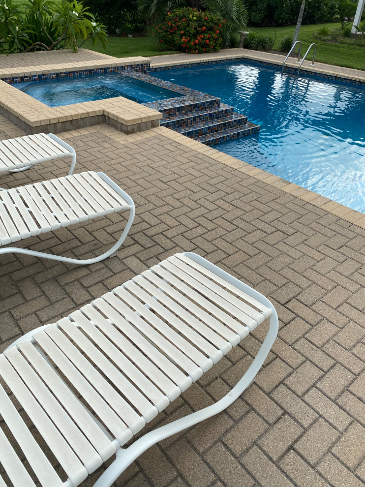 Example of a mid-sized trendy backyard brick and custom-shaped hot tub design in Austin