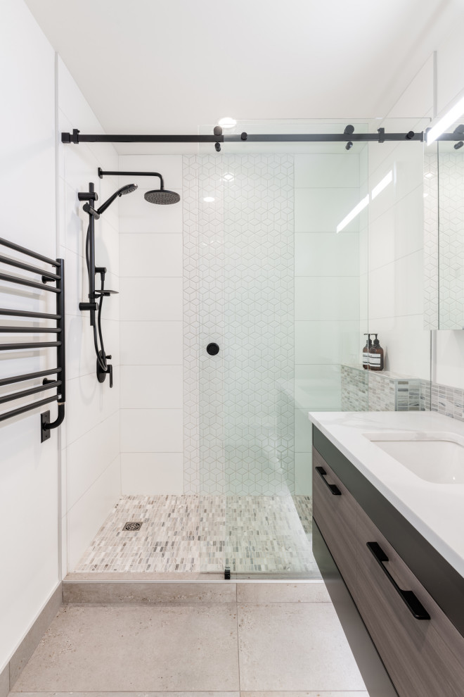 Inspiration for a small contemporary 3/4 bathroom in Vancouver with flat-panel cabinets, beige cabinets, an alcove shower, a two-piece toilet, white tile, porcelain tile, white walls, porcelain floors, an integrated sink, engineered quartz benchtops, grey floor, a sliding shower screen, white benchtops, a single vanity and a floating vanity.