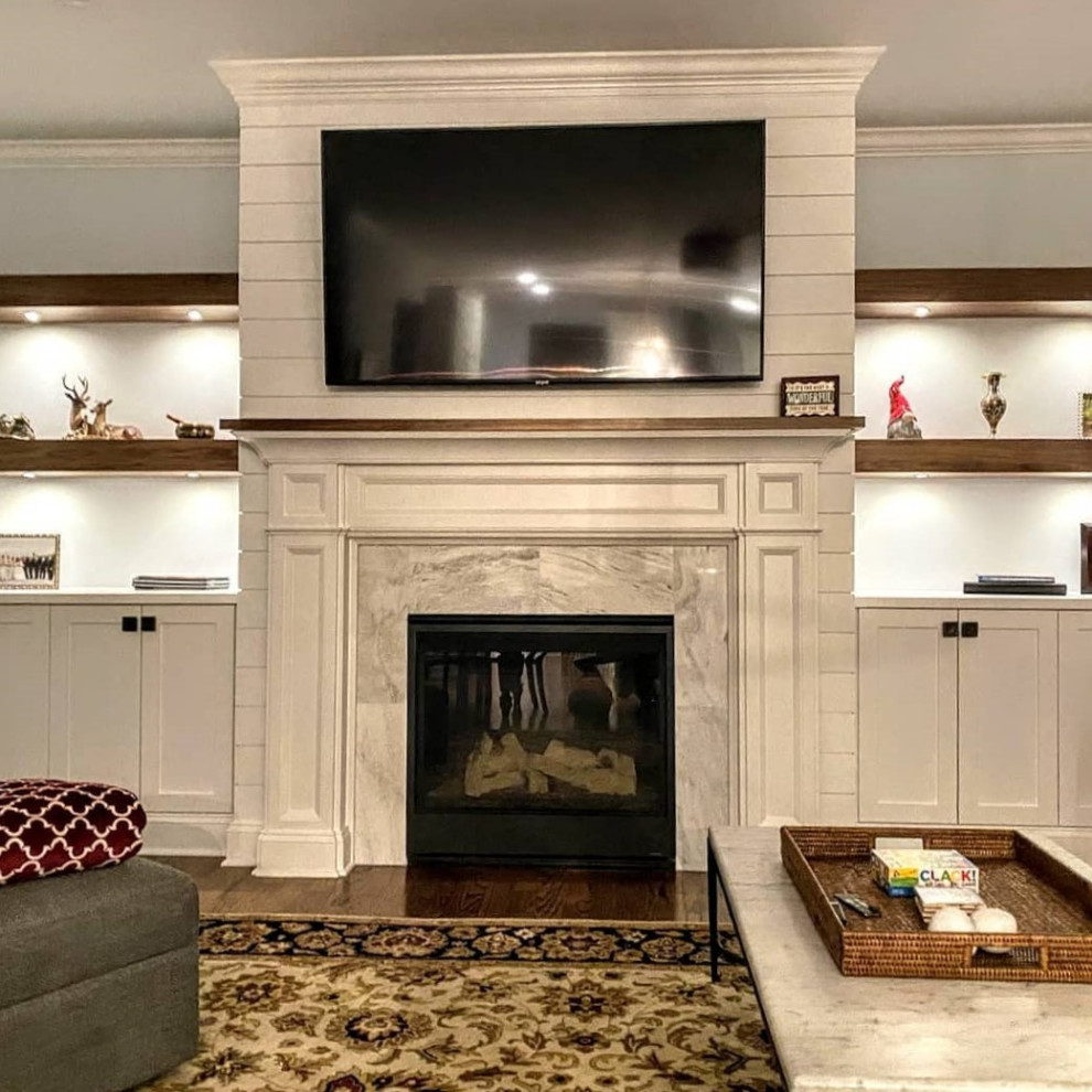 Elegant living room photo in New York with a standard fireplace and a tile fireplace