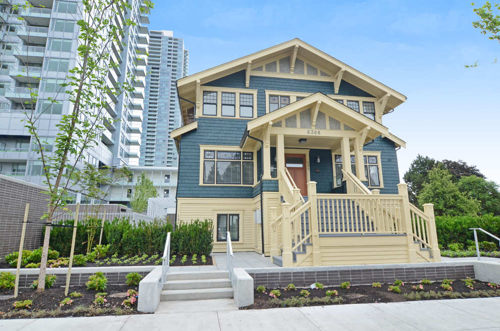 Mid-sized arts and crafts blue three-story mixed siding gable roof photo in Vancouver