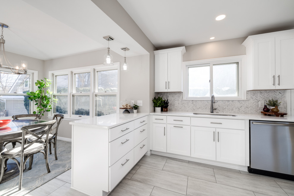 Example of a small transitional u-shaped vinyl floor and beige floor eat-in kitchen design in Other with a single-bowl sink, shaker cabinets, white cabinets, quartz countertops, gray backsplash, marble backsplash, stainless steel appliances, a peninsula and white countertops