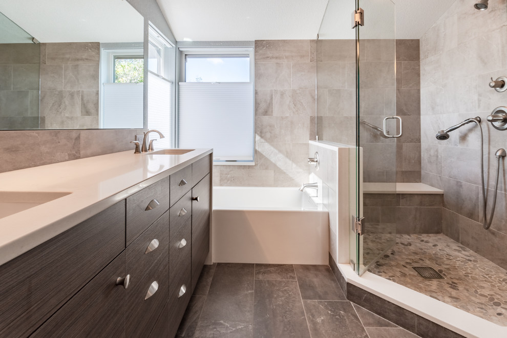 Photo of a transitional master bathroom in Denver with flat-panel cabinets, dark wood cabinets, an alcove tub, a corner shower, brown tile, porcelain tile, brown walls, porcelain floors, an undermount sink, engineered quartz benchtops, brown floor, a hinged shower door and white benchtops.