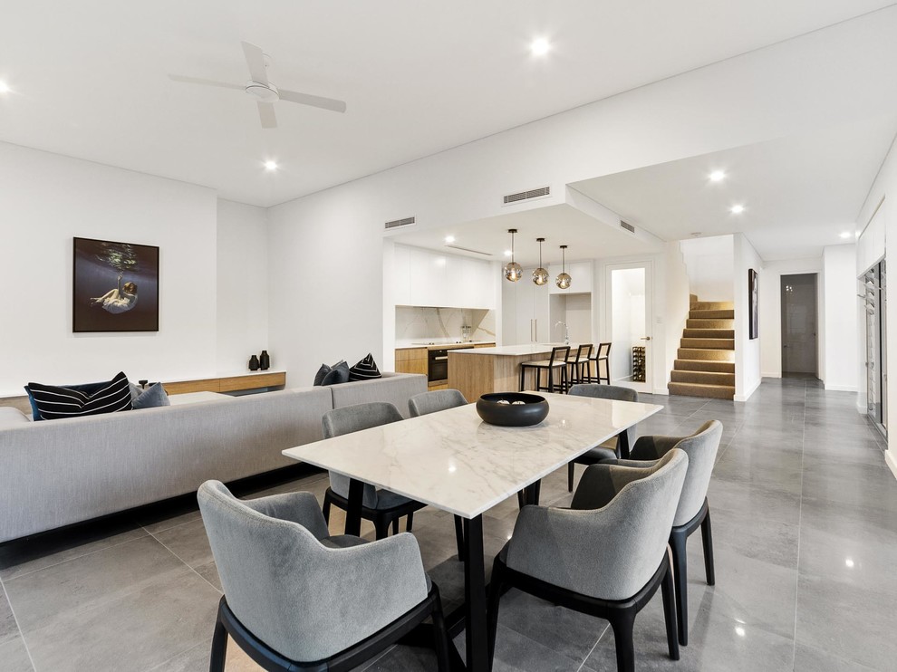 Inspiration for a large contemporary open plan dining in Perth with white walls, ceramic floors, no fireplace and grey floor.