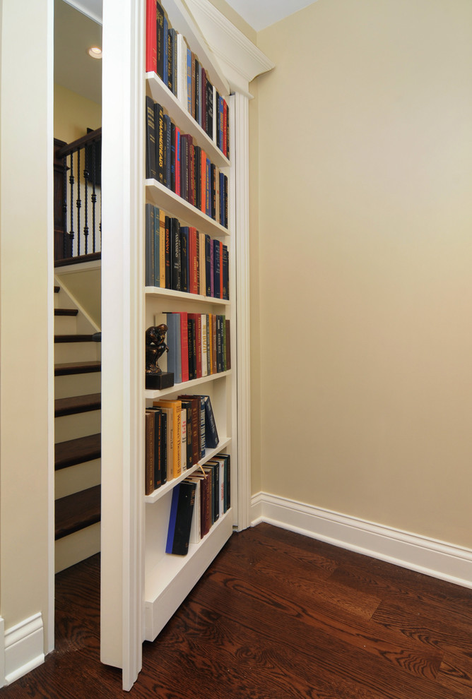 Inspiration for a traditional wood straight staircase in Chicago with painted wood risers.