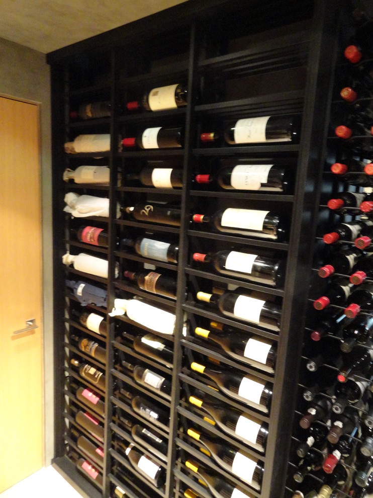 Mid-sized traditional wine cellar in Los Angeles with ceramic floors and display racks.