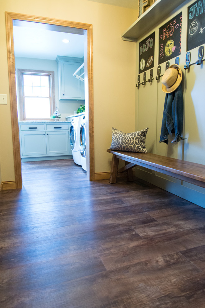 Photo of a transitional entryway in Other with yellow walls, brown floor and vinyl floors.
