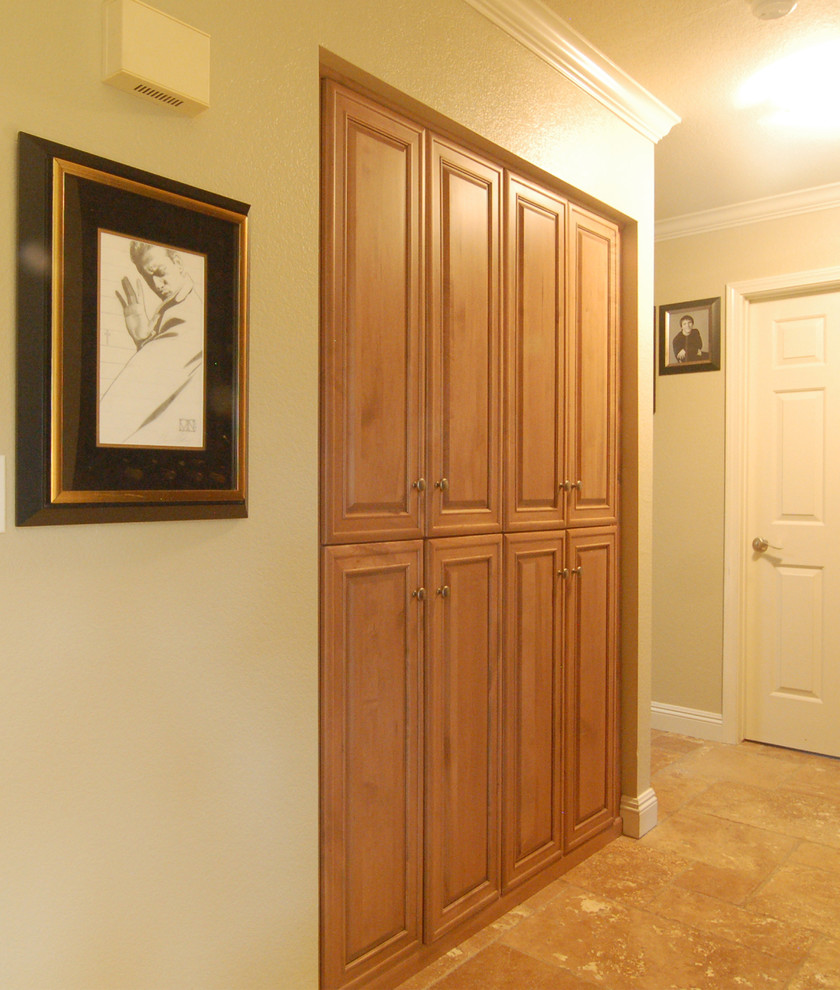 Photo of a small transitional hallway in San Luis Obispo with green walls and travertine floors.