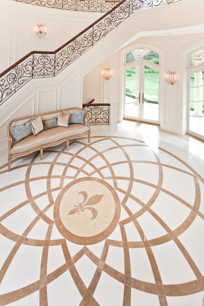Photo of an expansive traditional foyer in Chicago with beige walls, marble floors and a double front door.