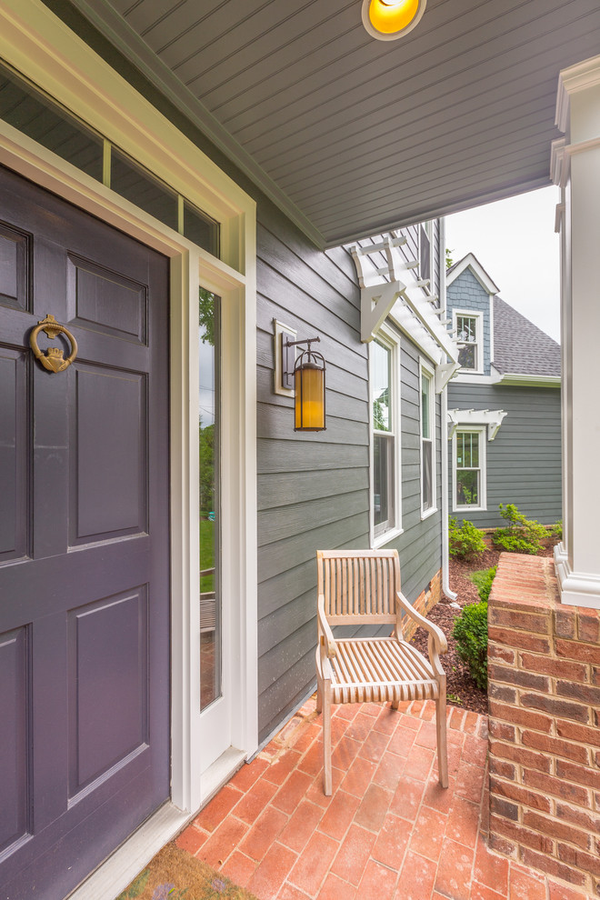 Example of a mid-sized classic front door design with gray walls and a blue front door