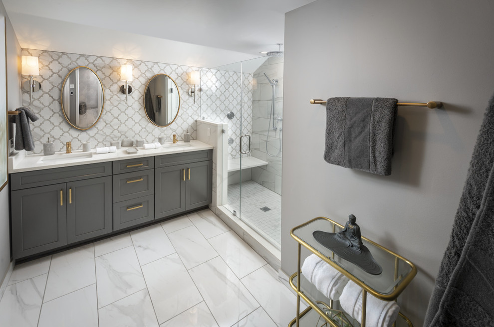 Photo of a mid-sized transitional master bathroom in Philadelphia with shaker cabinets, grey cabinets, a double shower, a wall-mount toilet, white tile, porcelain tile, grey walls, porcelain floors, a drop-in sink, quartzite benchtops, white floor, a hinged shower door, white benchtops, a shower seat, a double vanity, a built-in vanity and wallpaper.