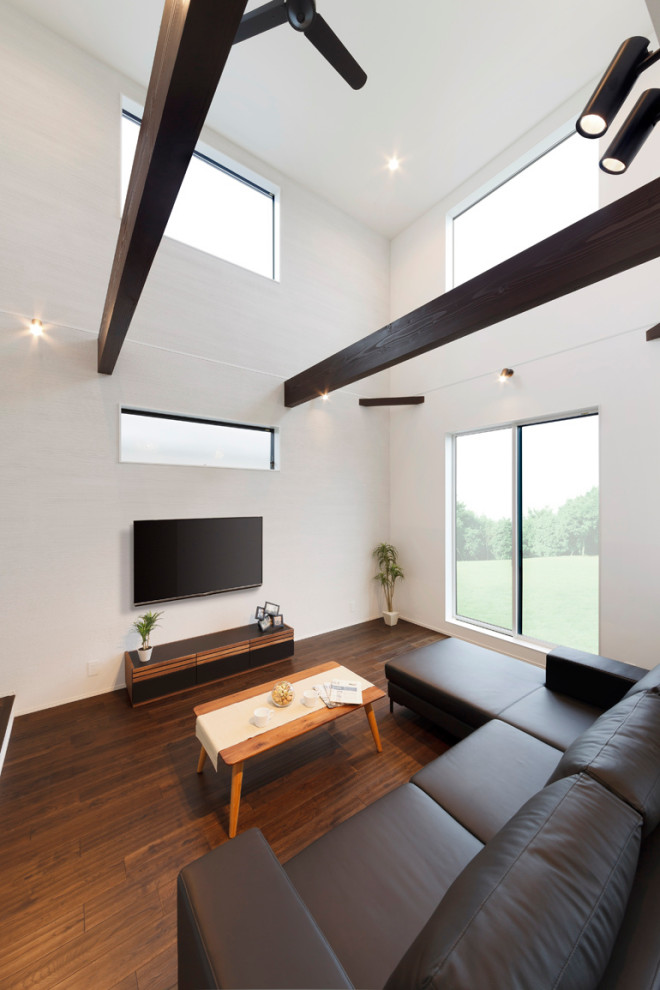 Contemporary open concept living room in Other with white walls, dark hardwood floors, a wall-mounted tv, brown floor, timber and planked wall panelling.