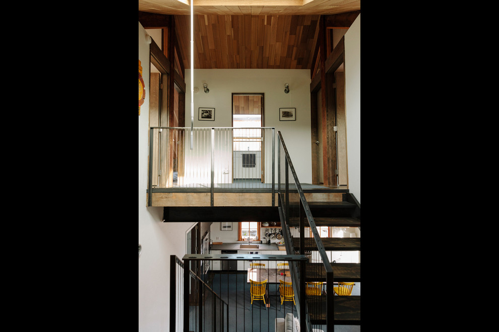 Photo of a large industrial wood u-shaped staircase in Portland with open risers.