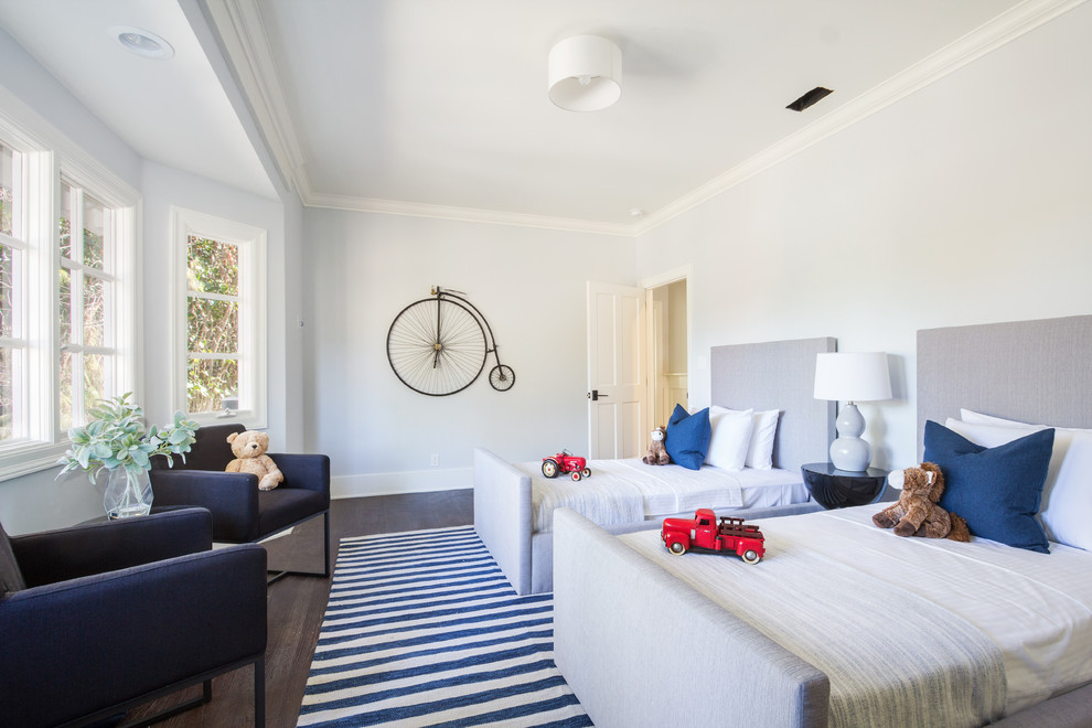 This is an example of a transitional kids' bedroom for kids 4-10 years old and boys in Los Angeles with blue walls and dark hardwood floors.