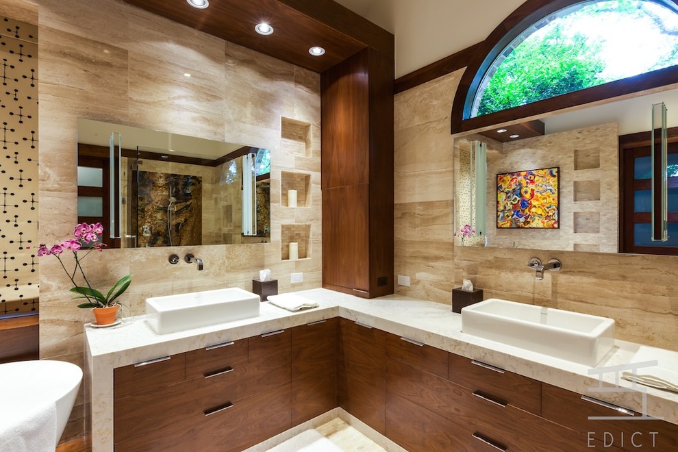 Photo of a mid-sized modern master bathroom in Dallas with a wall-mount sink, flat-panel cabinets, medium wood cabinets, engineered quartz benchtops, a freestanding tub, a corner shower, a wall-mount toilet, beige tile, stone tile, beige walls and marble floors.