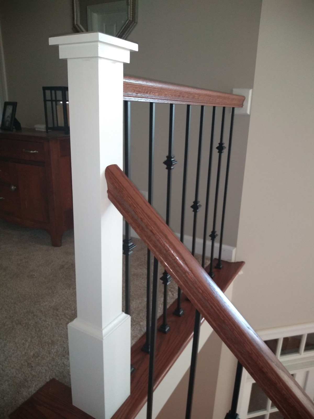 White newels with oak rails and iron balusters