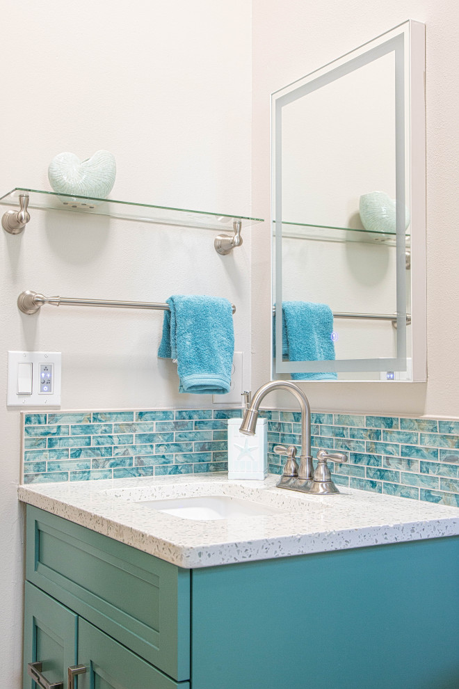 Design ideas for a small coastal family bathroom in Orlando with shaker cabinets, turquoise cabinets, blue tiles, porcelain tiles, engineered stone worktops, turquoise floors, white worktops, a single sink and a built in vanity unit.