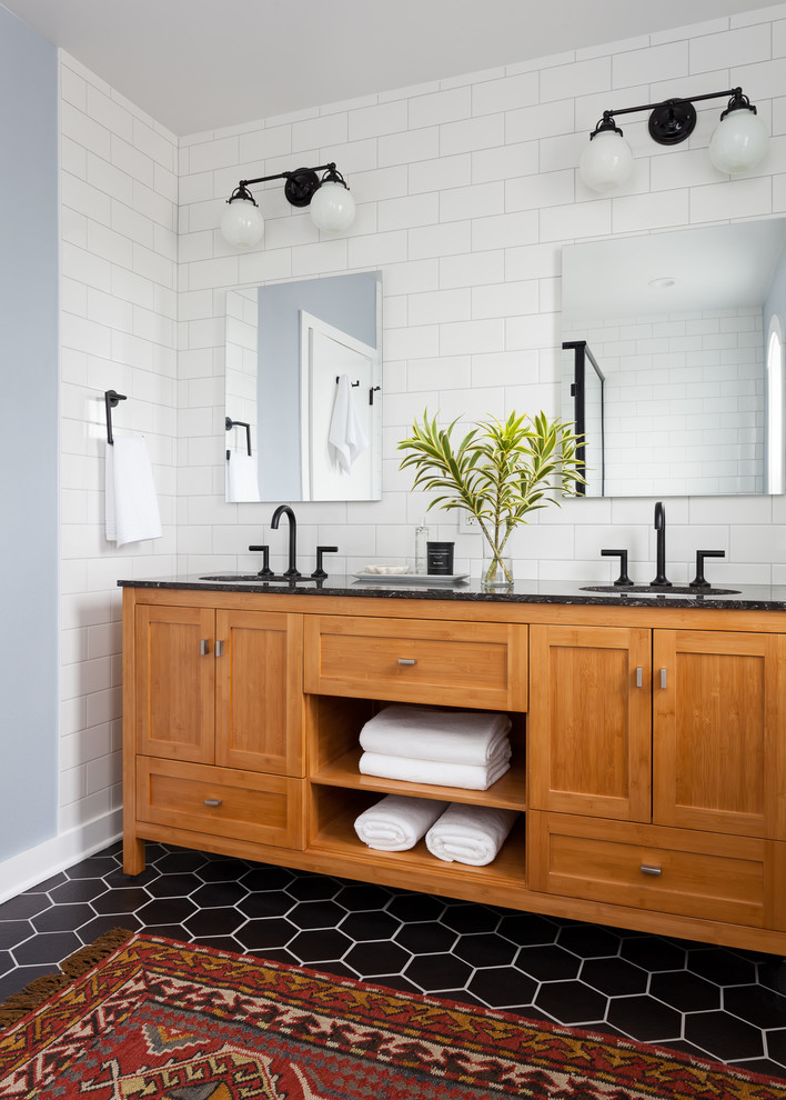 Design ideas for a mid-sized transitional master bathroom in Seattle with shaker cabinets, medium wood cabinets, black and white tile, ceramic tile, grey walls, porcelain floors, an undermount sink, engineered quartz benchtops, a corner shower, a one-piece toilet and black floor.