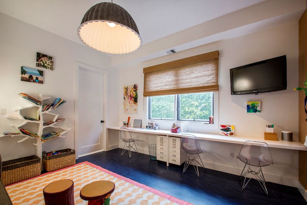 This is an example of a contemporary gender-neutral kids' study room for kids 4-10 years old in Los Angeles with white walls and dark hardwood floors.
