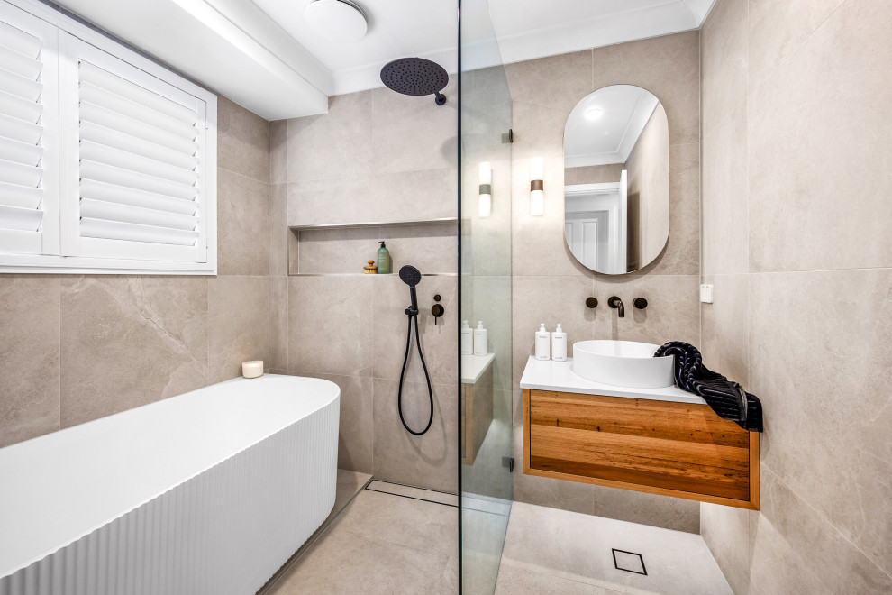 This is an example of a mid-sized contemporary master wet room bathroom in Central Coast with flat-panel cabinets, medium wood cabinets, a freestanding tub, gray tile, grey walls, a vessel sink, green floor, an open shower, white benchtops, a niche, a single vanity and a floating vanity.
