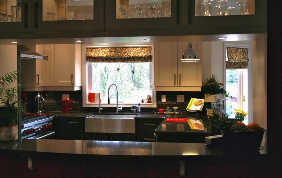 Eat-in kitchen - mid-sized transitional u-shaped porcelain tile eat-in kitchen idea in Toronto with a farmhouse sink, shaker cabinets, dark wood cabinets, quartz countertops, brown backsplash, ceramic backsplash, stainless steel appliances and a peninsula