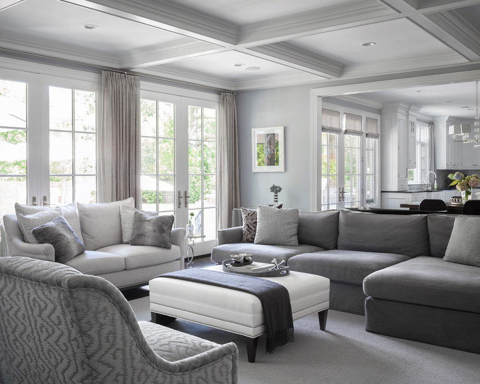 Transitional family room in New York with grey walls and carpet.