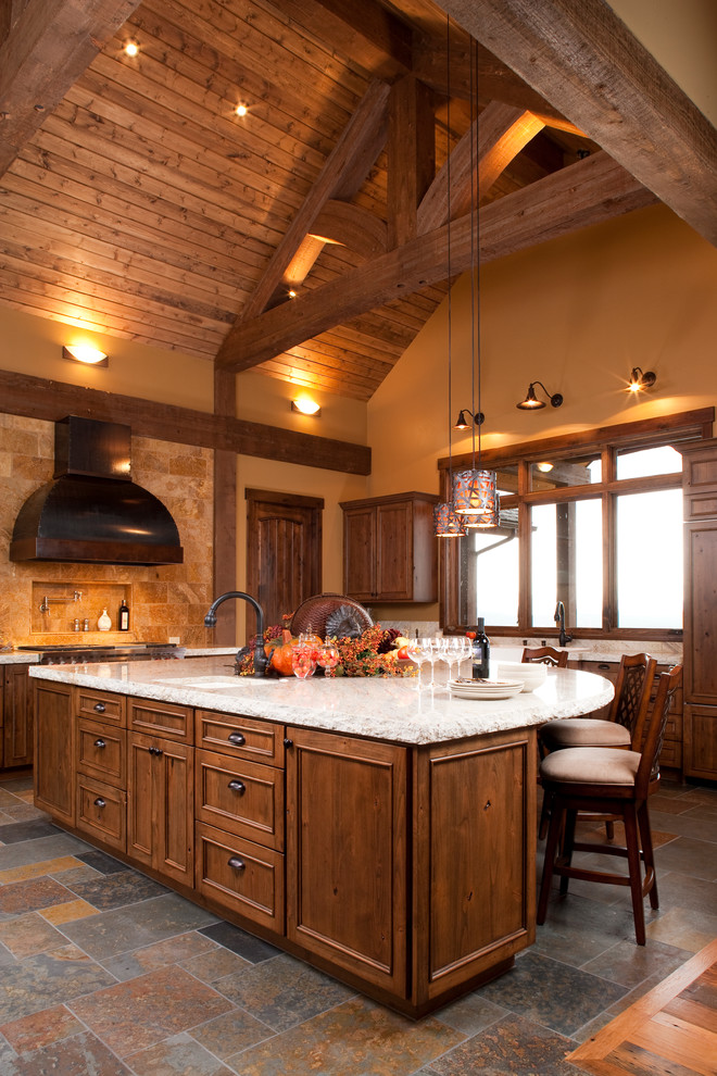 Photo of a traditional kitchen in Albuquerque with dark wood cabinets and beige splashback.