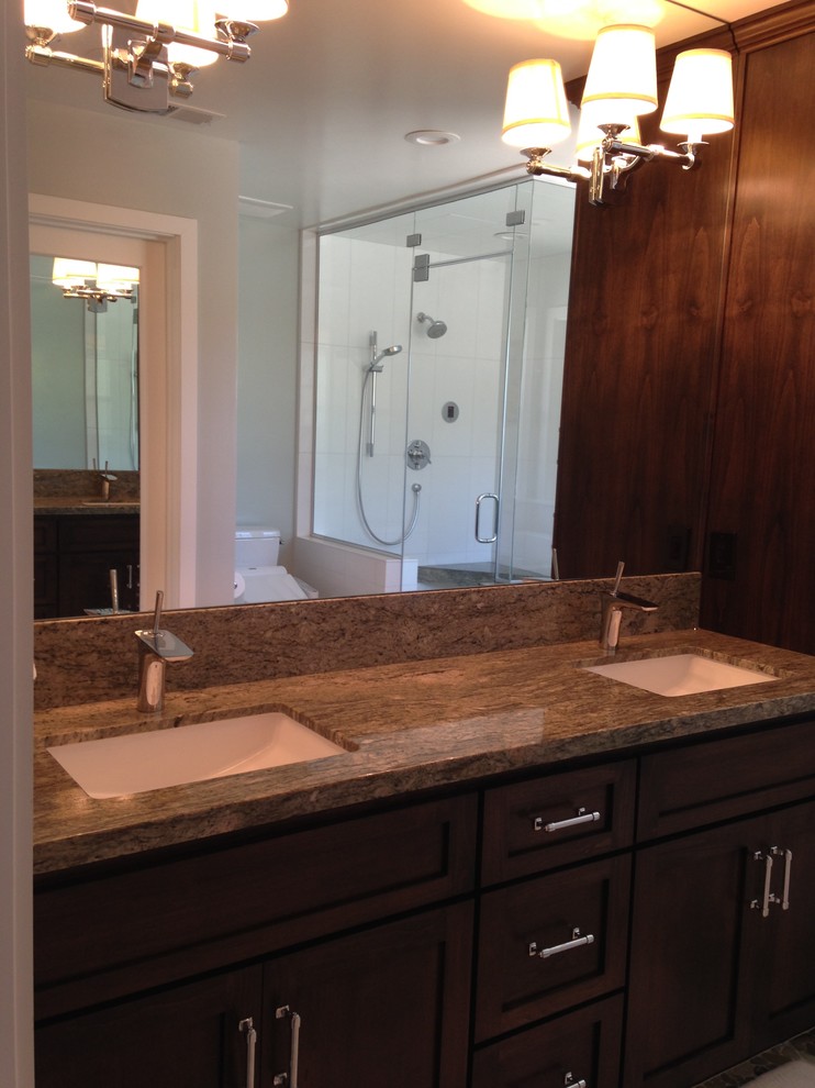 Photo of a mid-sized transitional master bathroom in San Luis Obispo with an undermount sink, shaker cabinets, dark wood cabinets, granite benchtops, a bidet, white tile, stone tile, blue walls and pebble tile floors.