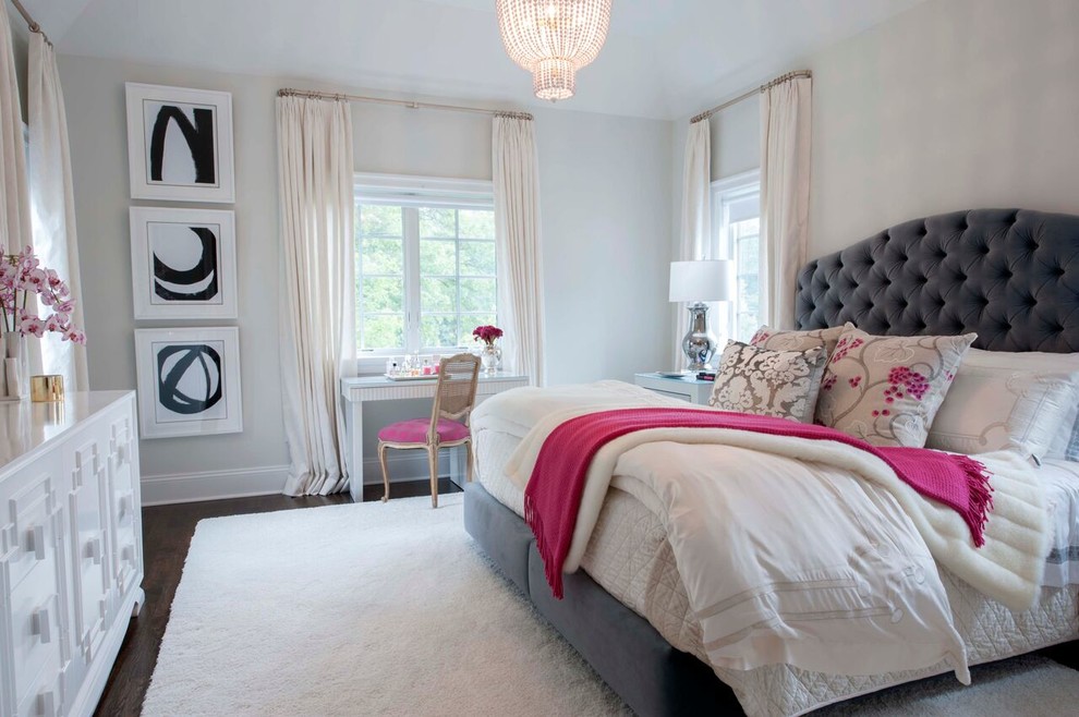 This is an example of a transitional bedroom in New York with white walls and dark hardwood floors.