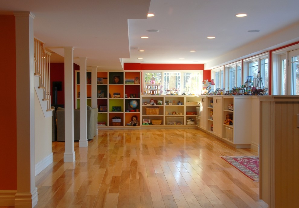 Inspiration for a traditional look-out basement in Burlington with red walls, no fireplace, light hardwood floors and orange floor.