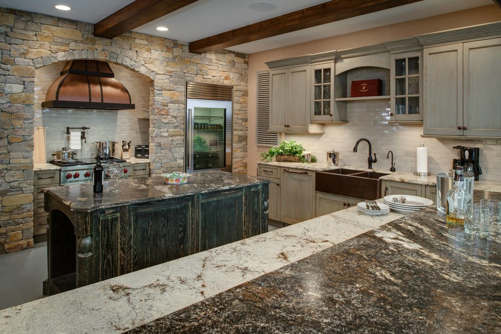 Photo of a mid-sized country u-shaped eat-in kitchen in Other with a farmhouse sink, white splashback, stainless steel appliances, concrete floors, recessed-panel cabinets, with island, distressed cabinets, granite benchtops and brick splashback.