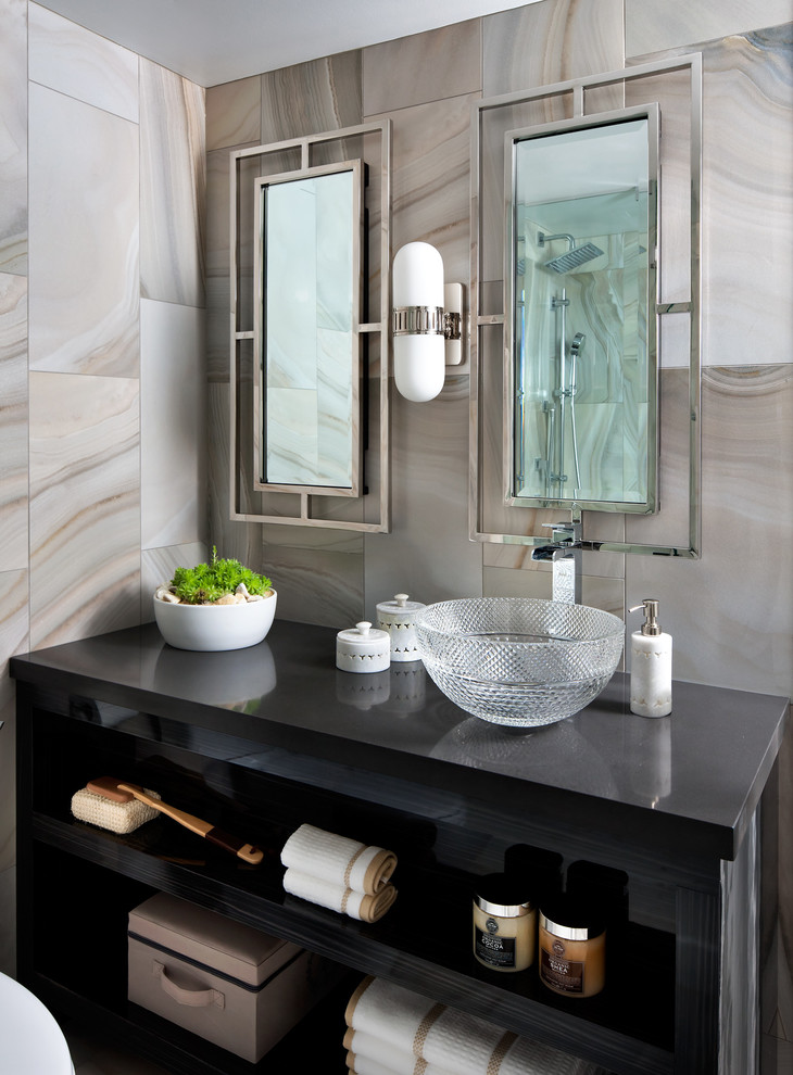 This is an example of a contemporary master bathroom in Toronto with quartzite benchtops and gray tile.