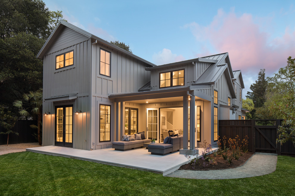 Inspiration for a large country two-storey grey house exterior in San Francisco with a gable roof, a metal roof, wood siding and board and batten siding.