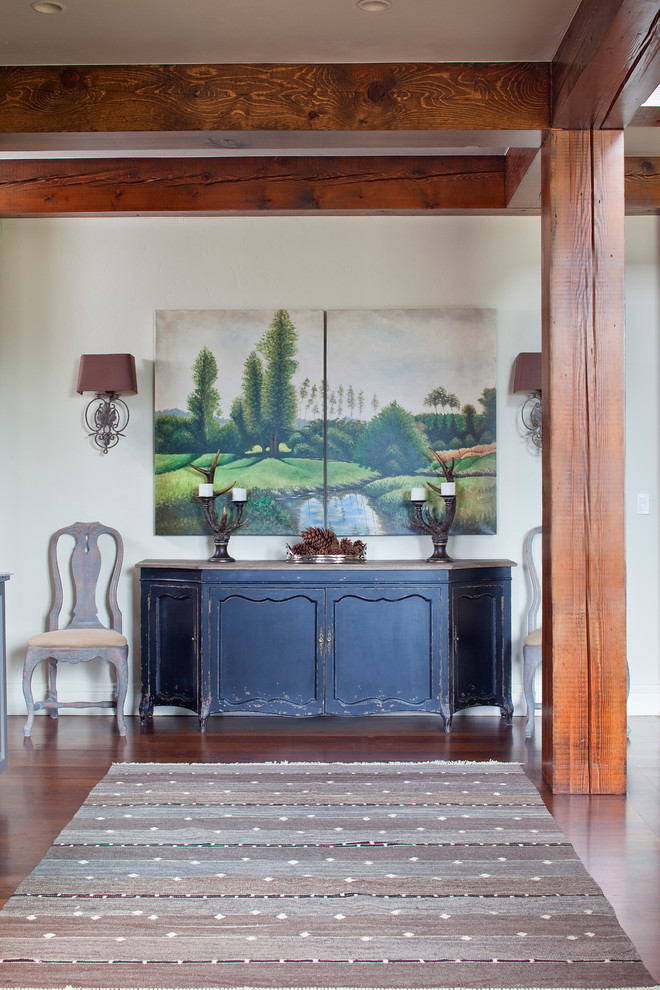 Design ideas for a country foyer in Denver with dark hardwood floors and white walls.