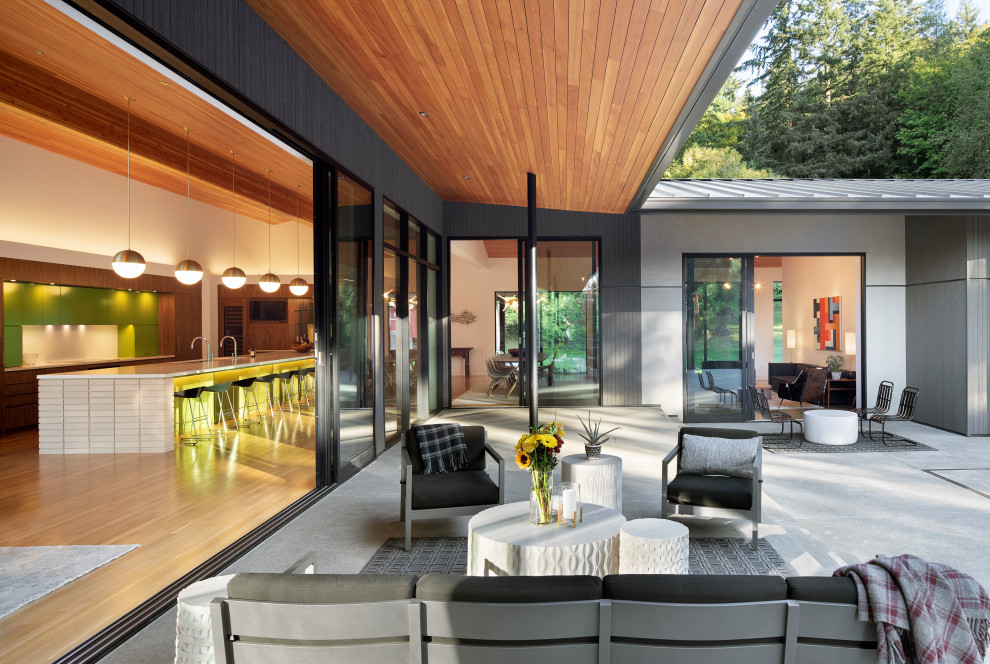 На фото: двор на внутреннем дворе в стиле ретро с летней кухней, покрытием из бетонных плит и навесом с