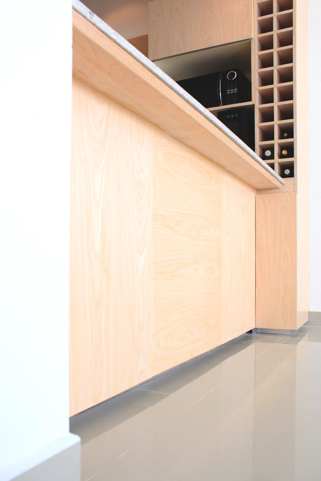 Eat-in kitchen - mid-sized modern u-shaped porcelain tile eat-in kitchen idea with a double-bowl sink, flat-panel cabinets, light wood cabinets, granite countertops and stainless steel appliances