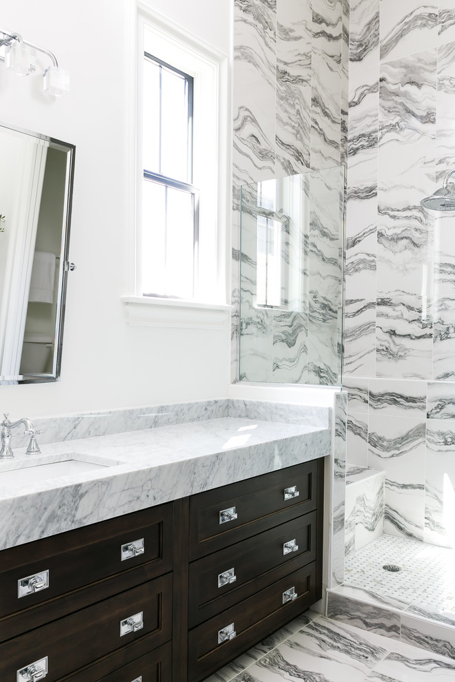 Mistflower - Example of a mid-sized transitional master white tile and porcelain tile porcelain tile and white floor alcove shower design in Louisville with beaded inset cabinets, dark wood cabinets, a two-piece toilet, white walls, an undermount sink, marble countertops and a hinged shower door